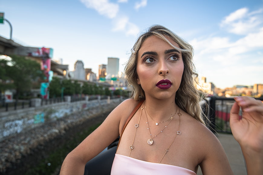 Stylish Blonde Woman Portrait with City Skyline Background