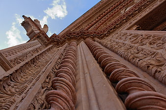 Low angle view of intricate sandstone temple architecture