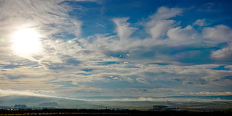 Panoramic landscape with dramatic clouds and morning mist