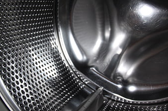 Close-up of stainless steel washing machine drum interior