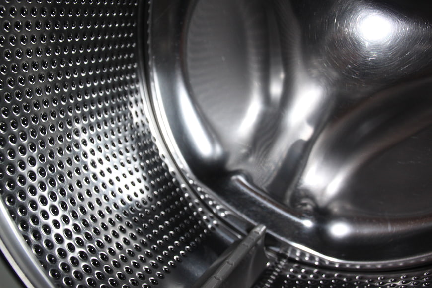 Close-up of stainless steel washing machine drum interior