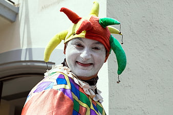 Portrait of a smiling court jester in colorful costume