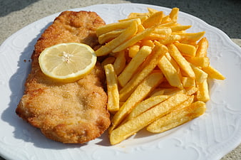 Golden Breaded Schnitzel with French Fries and Lemon Slice