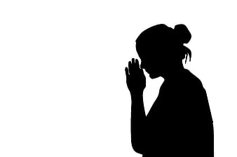 Silhouette of woman praying in profile