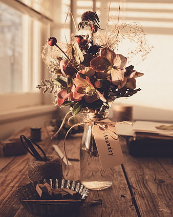 Rustic dried flower bouquet in glass jar with January tag