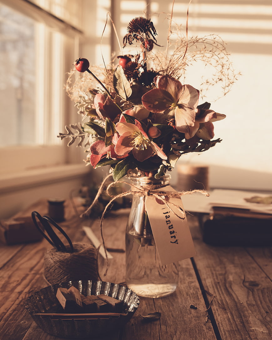 Rustic dried flower bouquet in glass jar with January tag