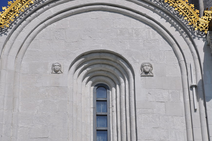 White stone cathedral facade with golden roof details