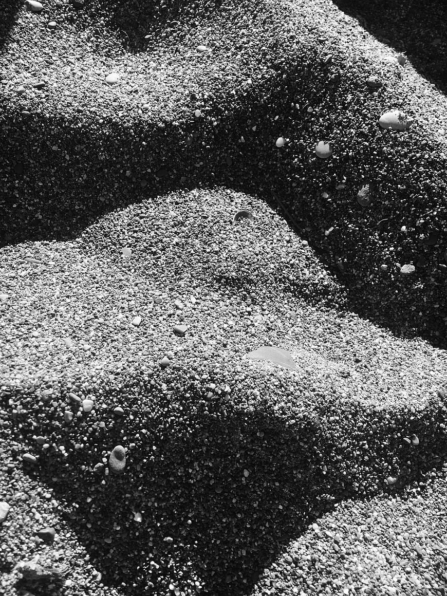 Black and white texture of sand and pebbles