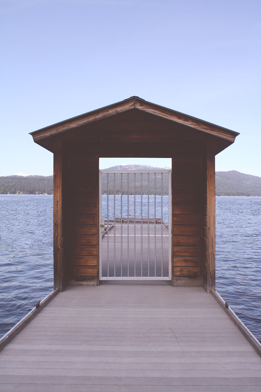 Wooden Dock Shed with Gate Overlooking Lake and Mountains