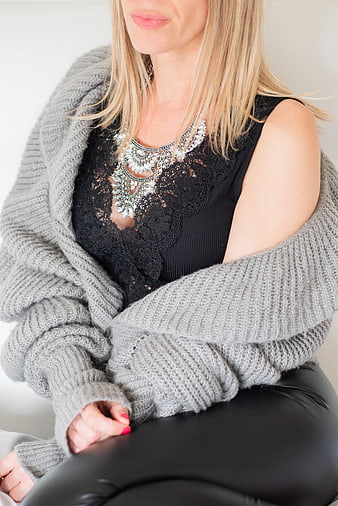 Woman in grey knit sweater and statement necklace