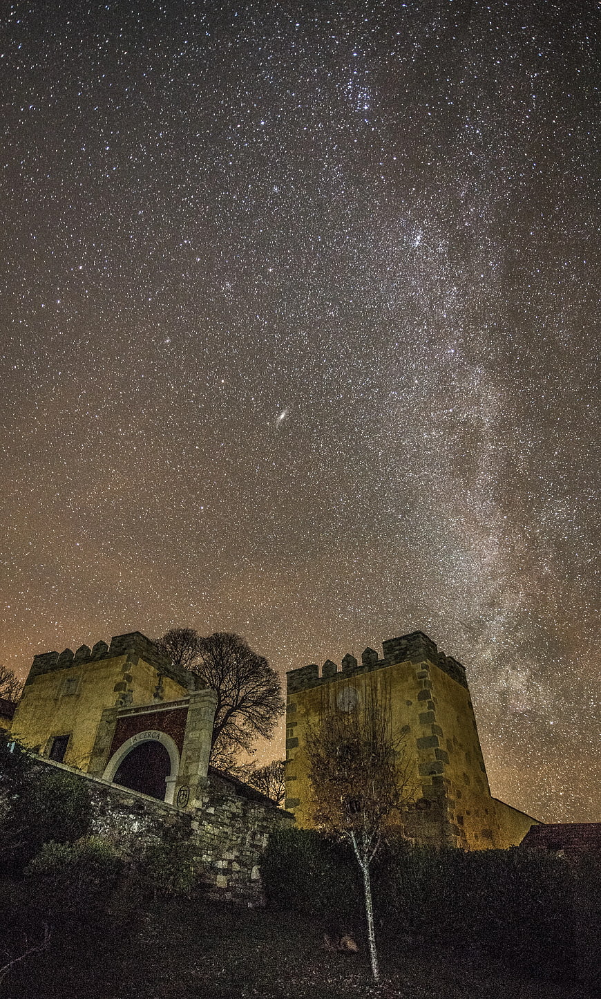 Milky Way over Historic Stone Gate at Night