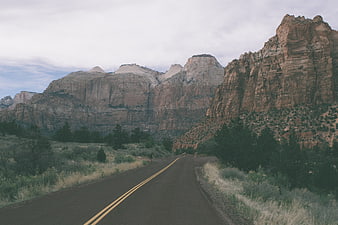 Desert highway winding through red rock canyon landscape
