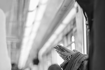 Woman Texting on Smartphone in Subway Car Interior