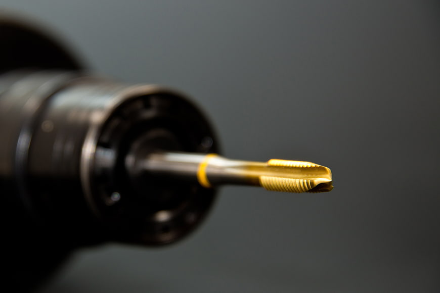 Close-up of gold-tipped drill bit in power tool
