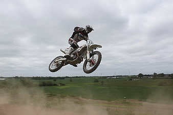 Motocross Rider Jumping Mid-Air on Dirt Track