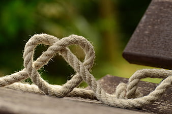 Close-up of Twisted Rope Knot on Wooden Surface