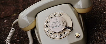 Vintage Cream Rotary Dial Telephone on Stone Surface