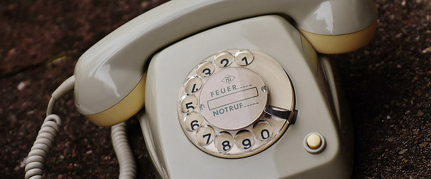 Vintage Cream Rotary Dial Telephone on Stone Surface