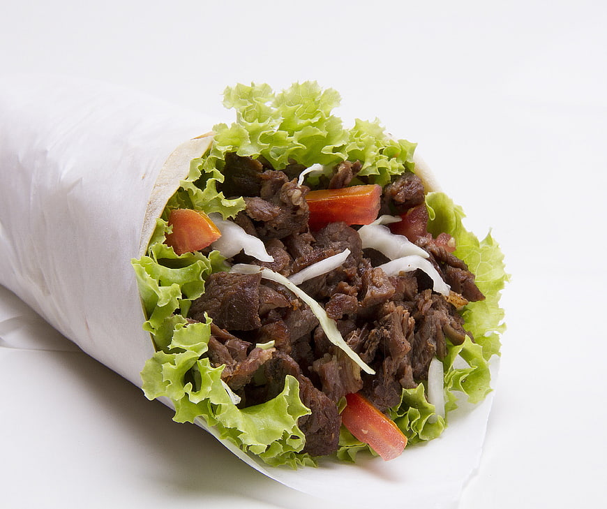 Beef Wrap With Fresh Lettuce, Tomato, And Onion On White Background