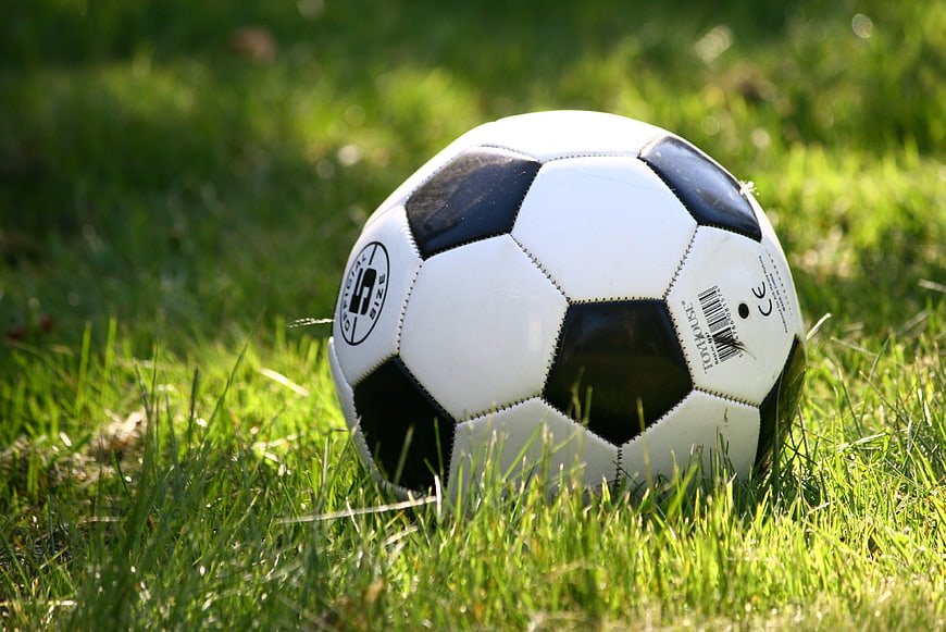 Classic black and white soccer ball on green grass