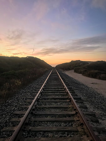 Railway Tracks Leading to Sunset Horizon