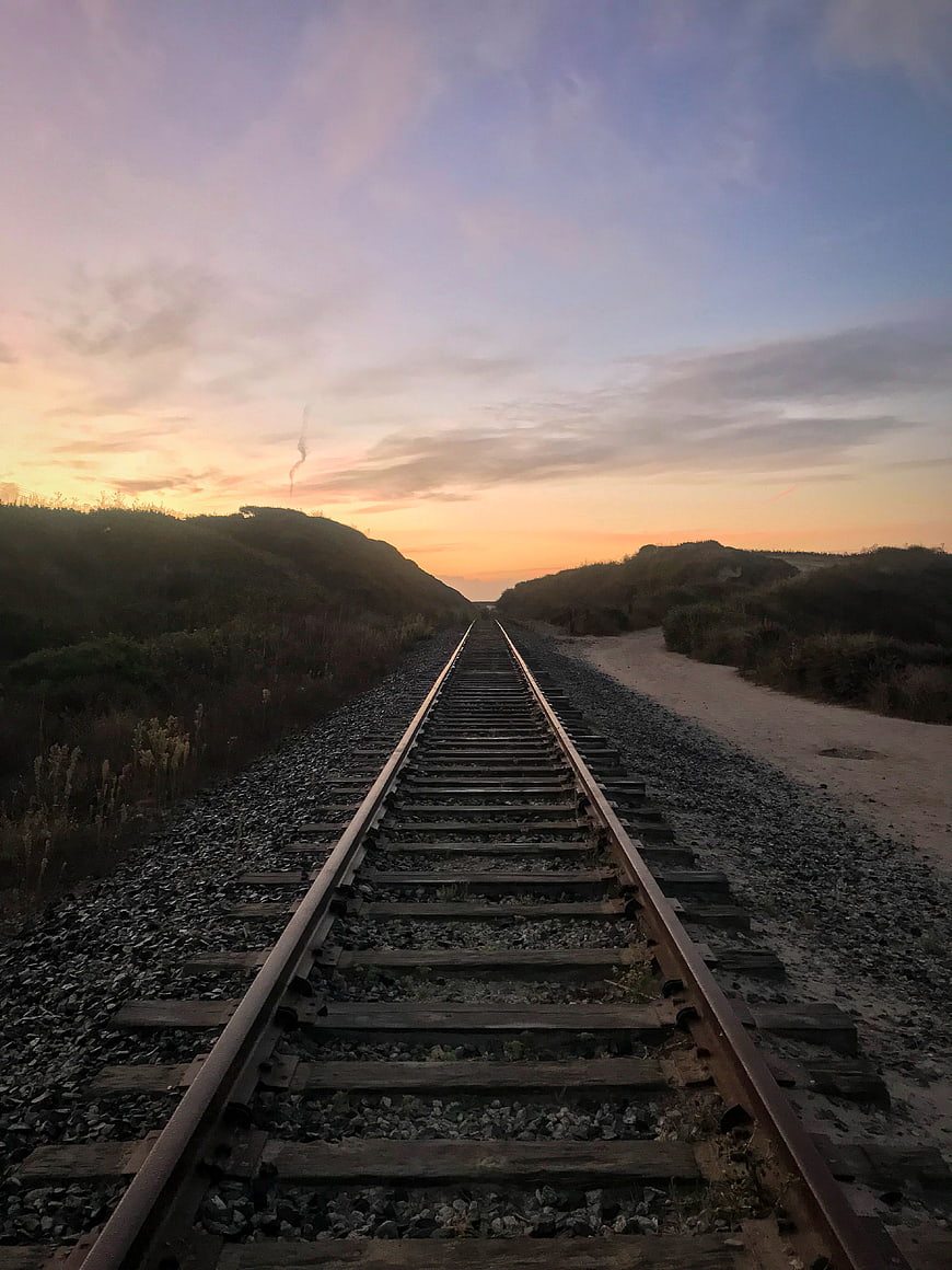 Railway Tracks Leading to Sunset Horizon