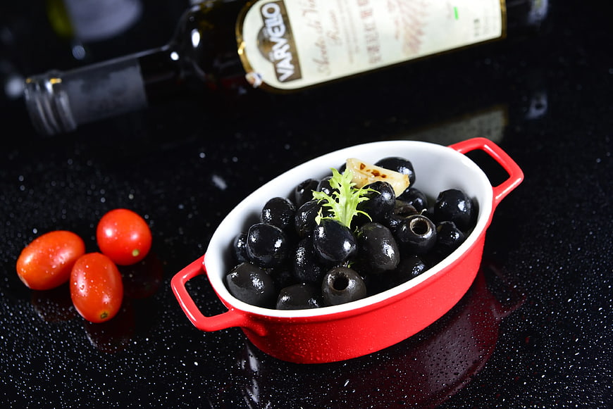 Black Olives in Red Bowl with Cherry Tomatoes and Olive Oil