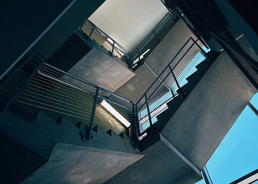 Low Angle View of Concrete Staircase with Metal Railings