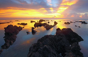 Dramatic Sunset Over Rocky Ocean Coastline