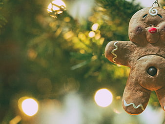 Gingerbread Man Christmas Ornament on Tree with Bokeh Lights