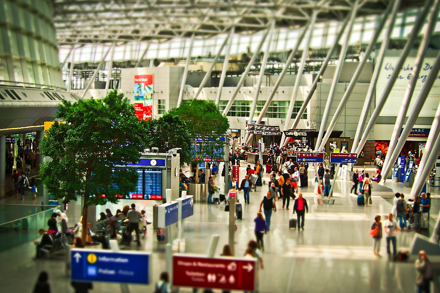Tilt-shift view of busy airport terminal with travelers