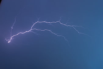 Dramatic Lightning Strike Against Deep Blue Sky