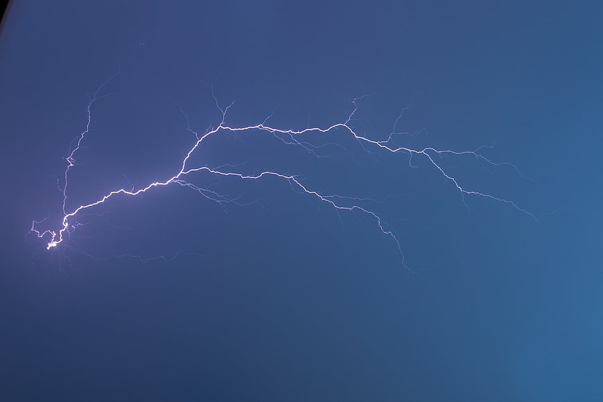 Dramatic Lightning Strike Against Deep Blue Sky