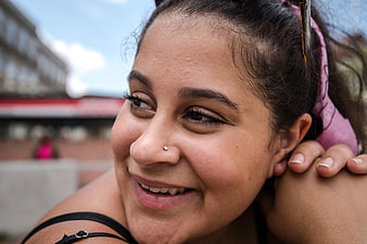 Close-up Portrait of Smiling Woman with Nose Piercing