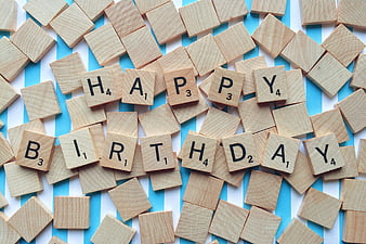 Happy Birthday Scrabble Tiles on Blue Striped Background
