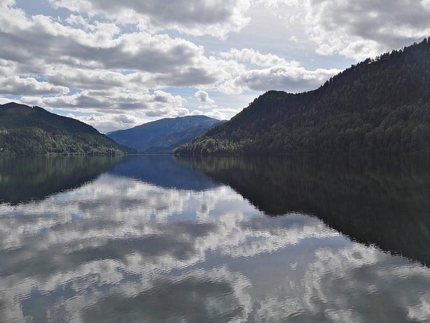 Serene Norwegian fjord landscape with cloud reflections