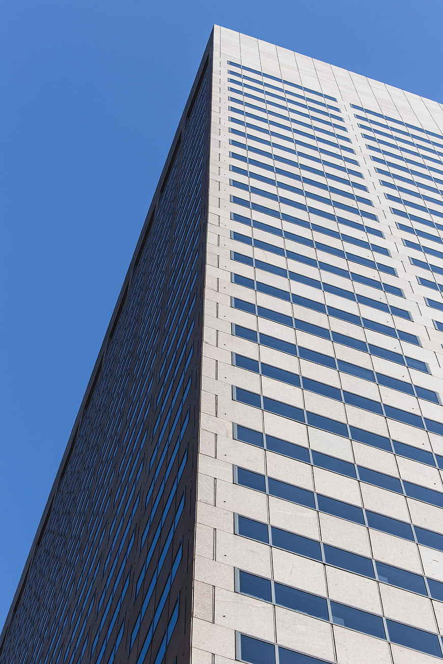 Low Angle View of Modern Skyscraper Against Blue Sky