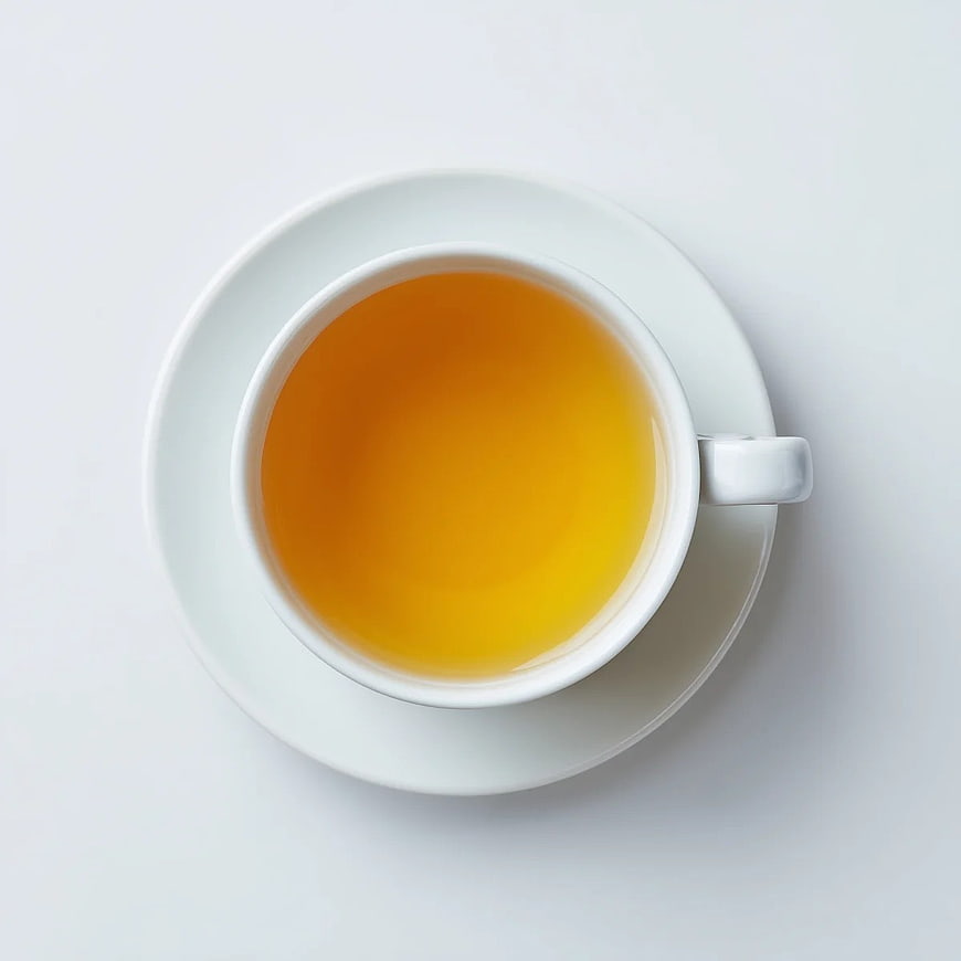 Top View of Golden Herbal Tea in White Cup