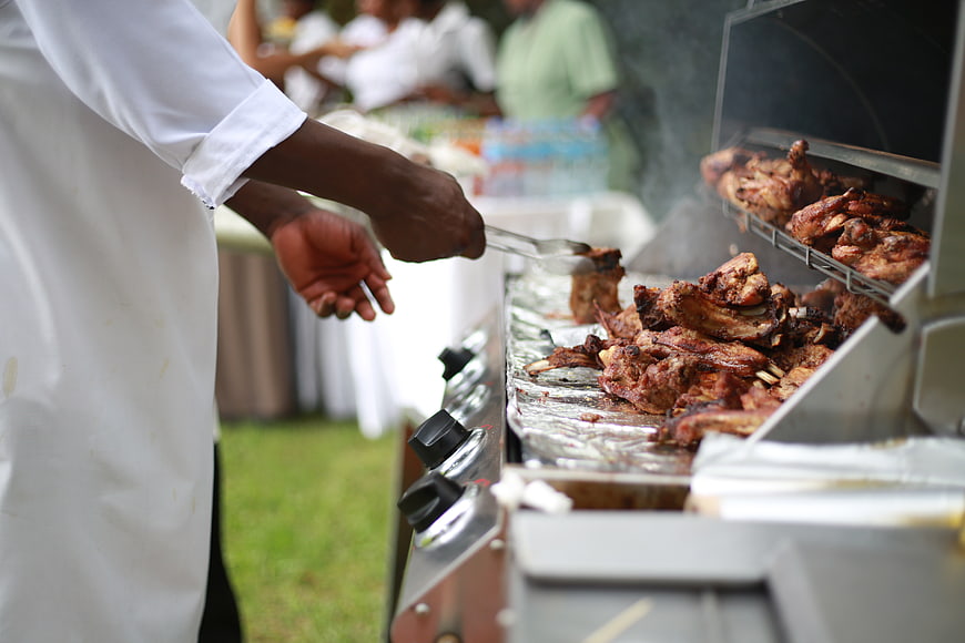 Chef Grilling Meat at Outdoor Catering Event