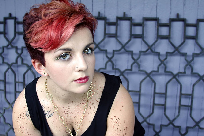 Portrait of woman with red hair and glitter makeup