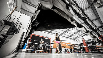 Woman Training in Boxing Gym with Heavy Bag