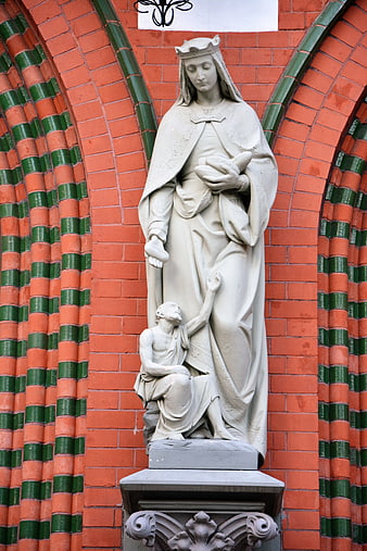 Stone Statue of Queen and Kneeling Figure on Brick Church
