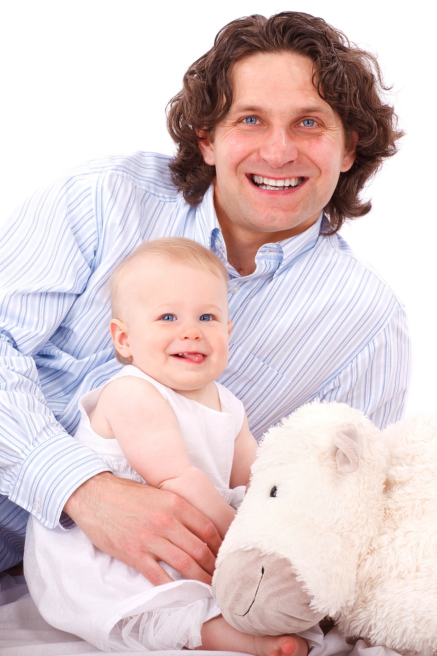 Smiling Father Holding Baby Girl With White Plush Toy