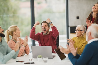 Happy diverse business team celebrating success in office meeting