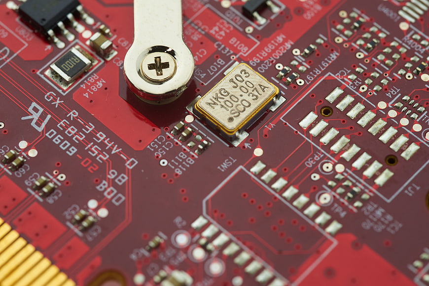 Close-up of red circuit board with electronic components