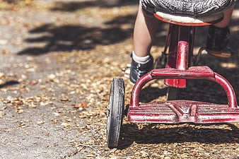 Child Riding Vintage Red Tricycle Outdoors
