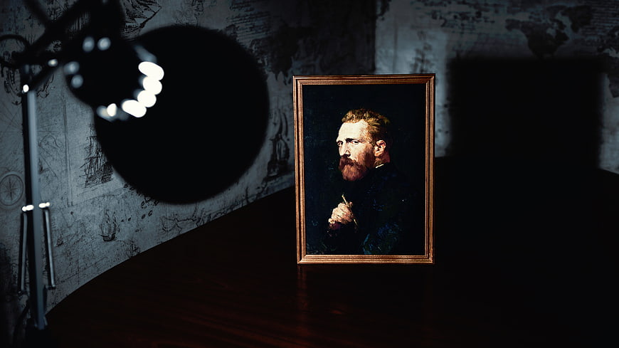 Framed Van Gogh Portrait Lit by Spotlight in Dark Room