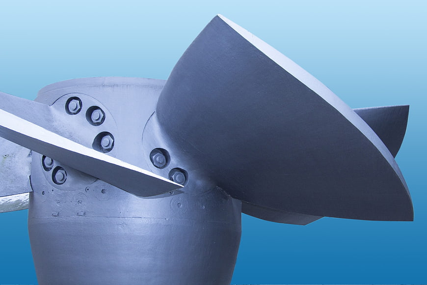 Close-up of a large gray industrial water turbine propeller