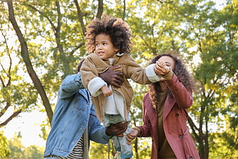 Happy African American Family Playing in Park