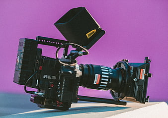 Professional RED Cinema Camera on Vibrant Purple Background